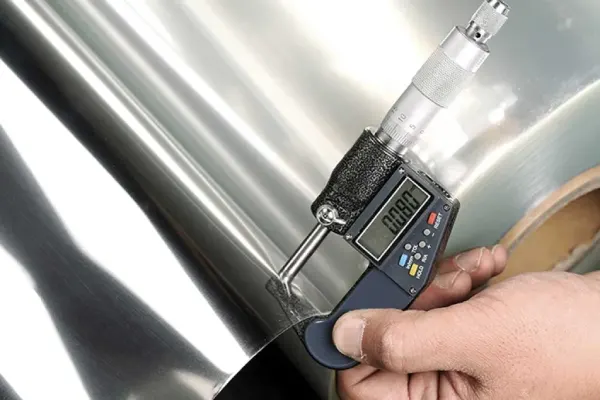Caliper checking plastic sheet thickness